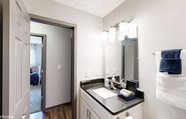 a bathroom with a large mirror and a sink