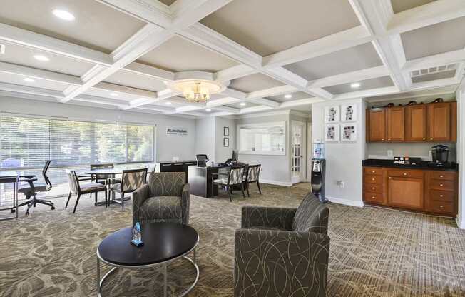 A well-lit, spacious living room with a dining area and kitchen in the background.