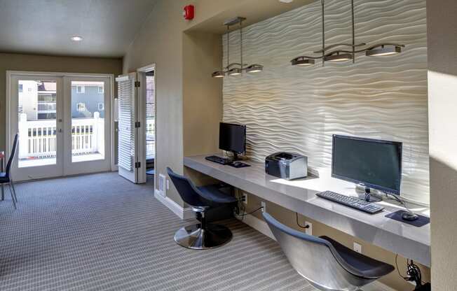 Resident business center with a desk with two computers and chairs at 2000 Lake Washington Apartments, Washington, 98056