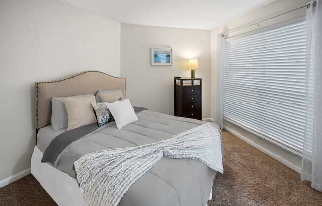 Bedroom with a bed and a large window at University Ridge Apartments, Durham, NC, 27707