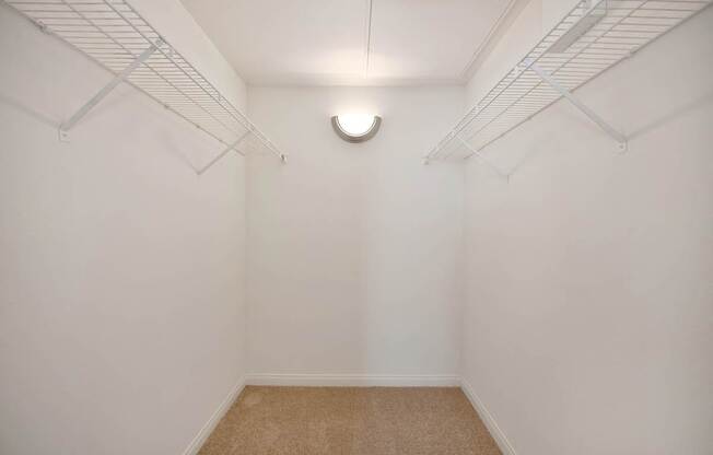 A small, empty room with a carpeted floor and white walls.