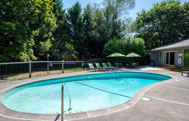 a resort style swimming pool in front of a house