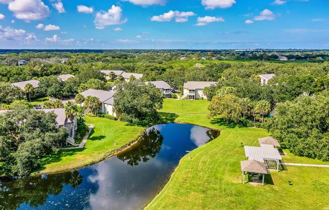 an aerial view of houses next to a body of water