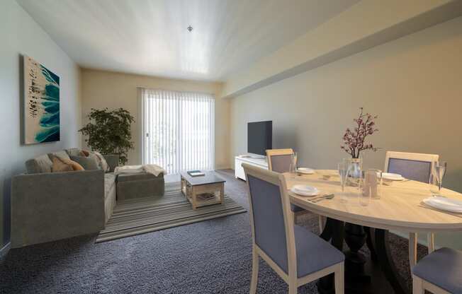a dining area with a table and chairs and a living room with a couch and tv at Mill Pond Apartments, Auburn, WA