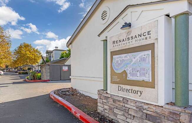 A sign for Renaissance Apartment Homes with a directory on it.