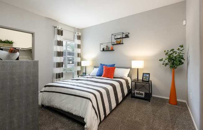 a bedroom with a bed and a dresser and a window