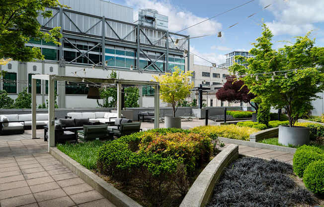 A modern outdoor seating area with a metal structure in the background.