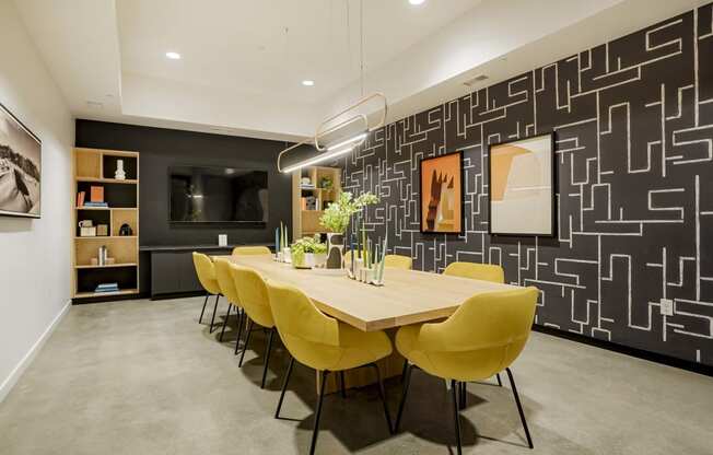 a dining room with a wooden table and yellow chairs