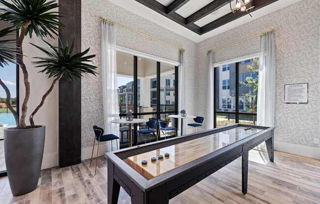 A modern dining room with a glass table and chairs.