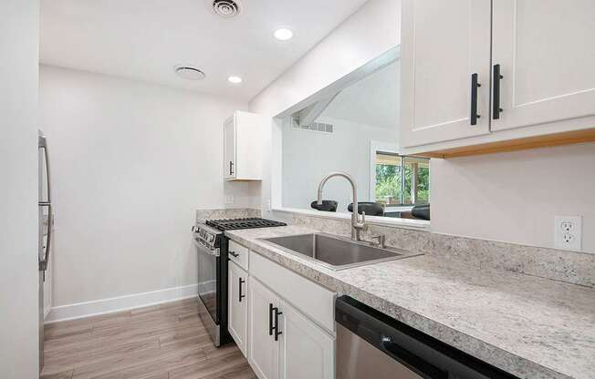 A modern kitchen with stainless steel appliances at Wingate Apartments, Kentwood