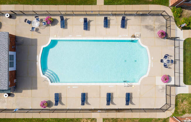 arial view of a swimming pool with umbrellas around it