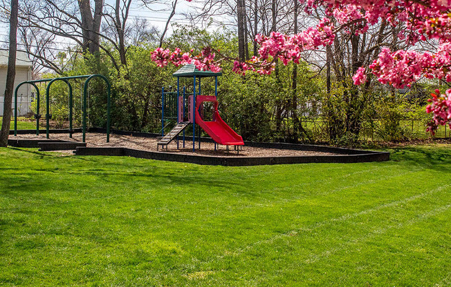 a playground with a swing set in a park