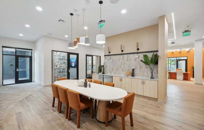 a dining room with a white table and chairs