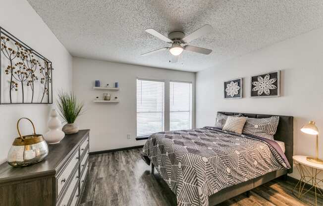 a bedroom with a bed and a ceiling fan