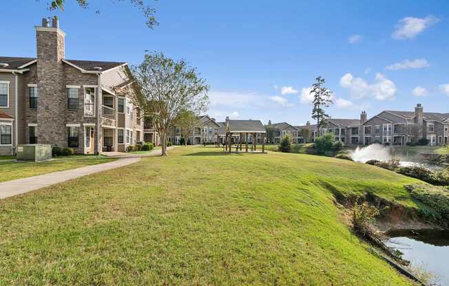 A row of houses with a grassy area in front.