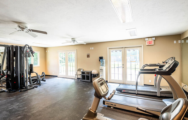 Apartment fitness center with treadmills, weights, and exercise equipment