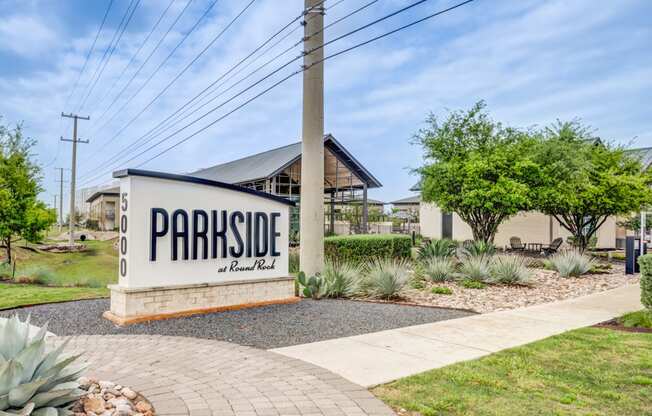 the sign for parkside at the cul de sac in front of a house