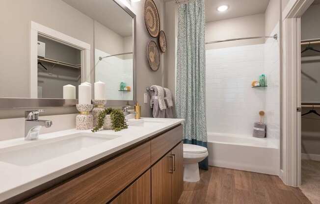 A bathroom with a white sink and a white toilet.