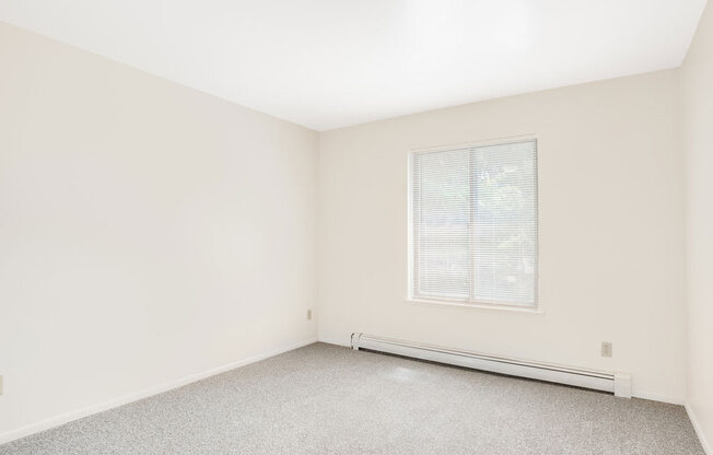 Bedroom with Large Window Private Balcony at Wood Creek Apartments in Kenosha, WI