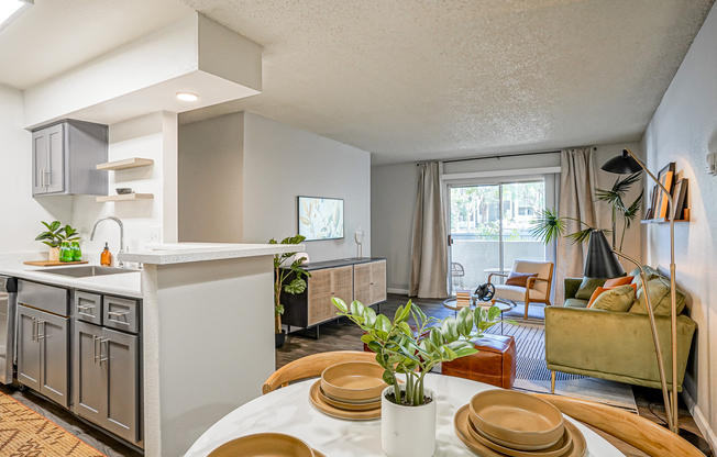 View of platinum living room and kitchen from dining area at Treehouse in Albuquerque, New Mexico