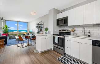 an open kitchen and living room with a view of the ocean