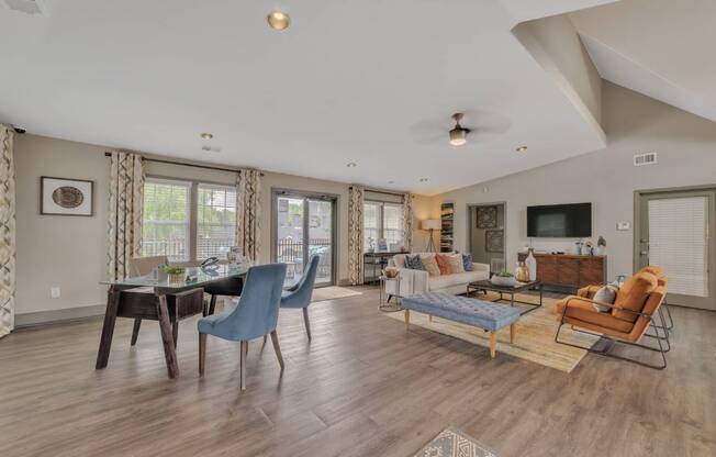 A living room with a dining table and chairs.