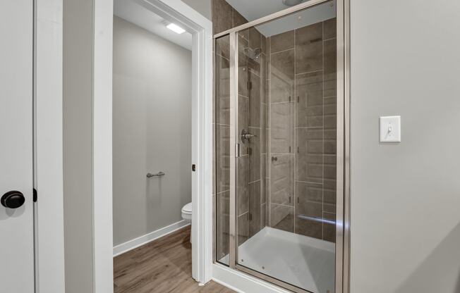 a bathroom with a shower and a toilet in it