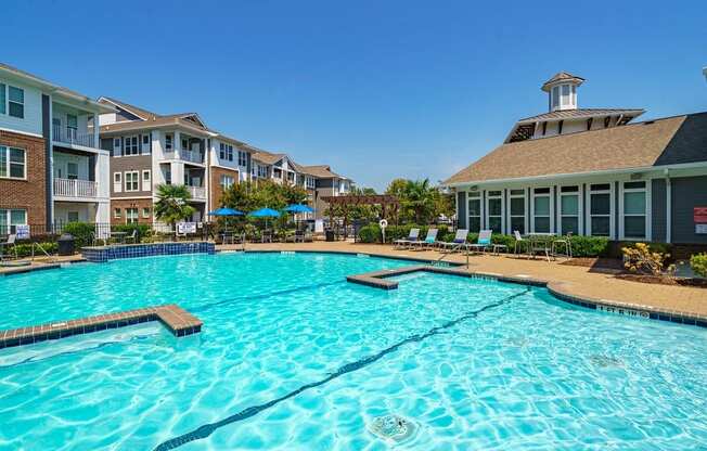 a large swimming pool with an apartment building in the background