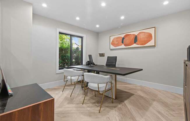 A conference room with a long table and chairs.