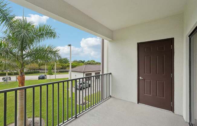A brown door is on the side of a house.