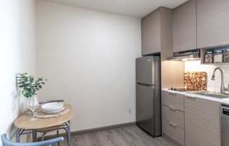 a kitchen with stainless steel appliances and a small table