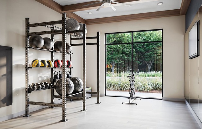 a fitness room with weights and a large window