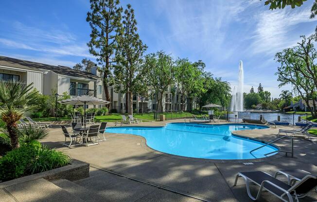 a blue pool of water in front of a building