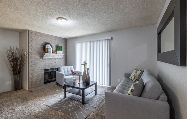 the living room of an apartment with a couch and a coffee table