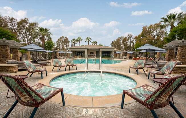 a swimming pool with chairs and umbrellas at the resort