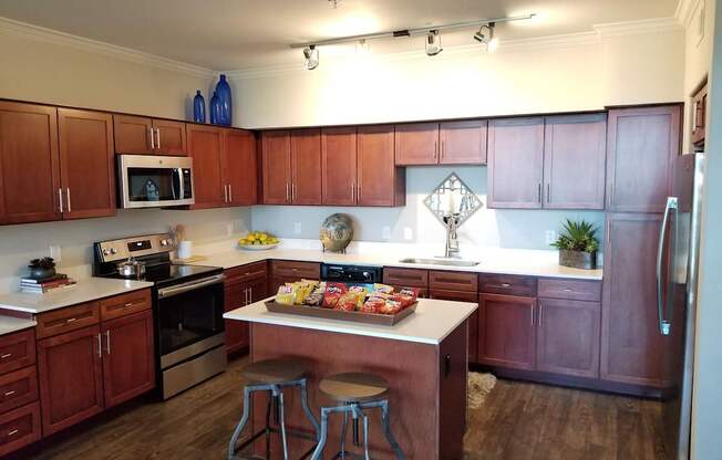 a kitchen with a center island with two stools in front of it