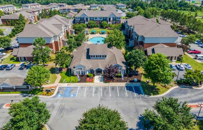 an aerial view of a neighborhood of houses with a swimming pool