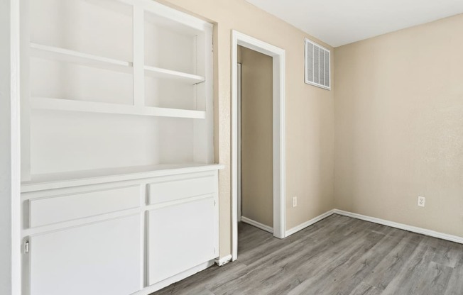 an empty room with white shelves and a door to a closet at Diamond Ridge Townhomes, Oklahoma City Oklahoma