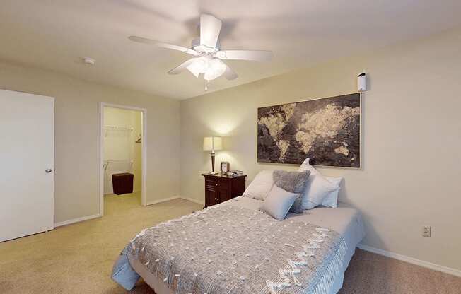 a bedroom with a ceiling fan