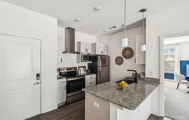 a kitchen with a counter top and a stove and a microwave