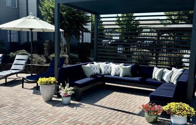 a patio with couches and a canopy