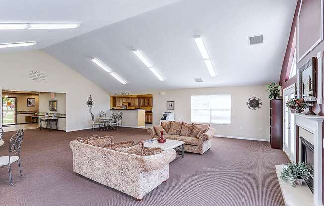 A living room with a couch, chair, and fireplace.