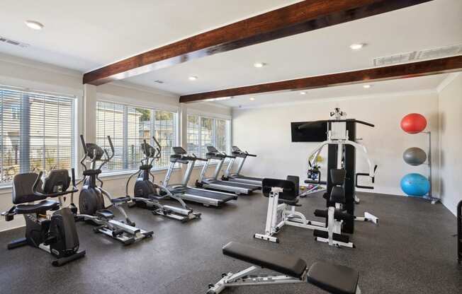 Gym with treadmills and other exercise equipment and windows  at The Meadows, Bloomingdale, GA