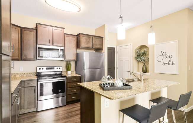 a kitchen with stainless steel appliances and a granite countertop