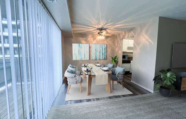 a dining room with a table and chairs and a ceiling fan