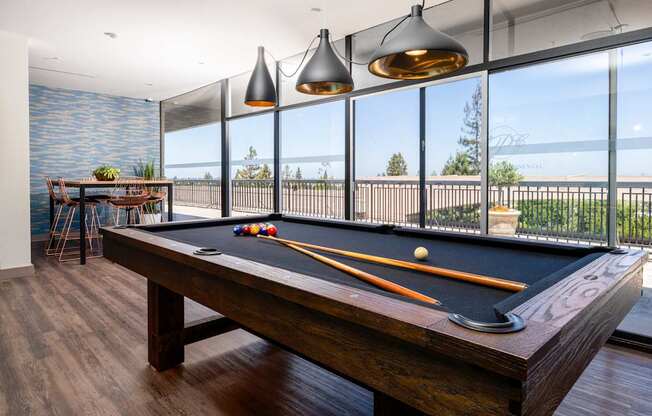 A pool table with a view of the ocean.