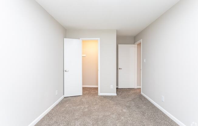 an empty room with white walls and doors