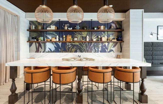 a kitchen with a marble counter top and chairs