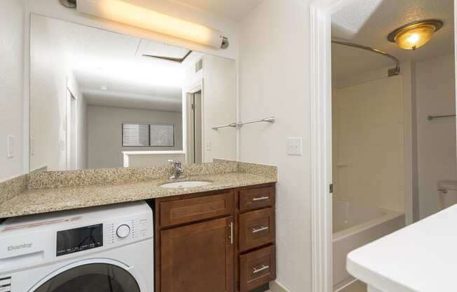 a kitchen with a sink and a washer and dryer