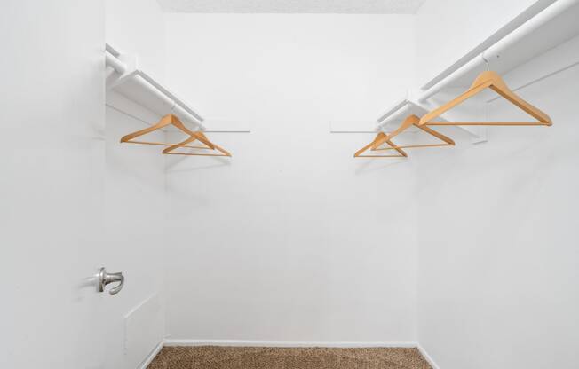 a white room with two hanging racks on the wall